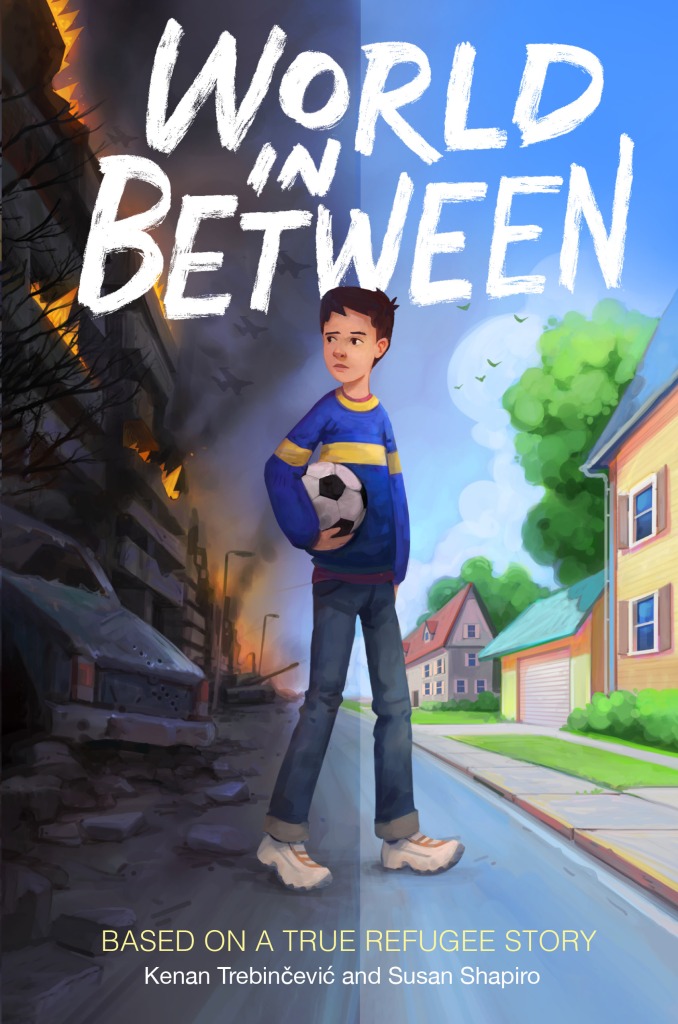 image has young boy holding soccer ball under right arm on middle of road. right side has houses with blue sky and left side has rubble and burning building with dark smoke around. large white letters across top reads World in Between.